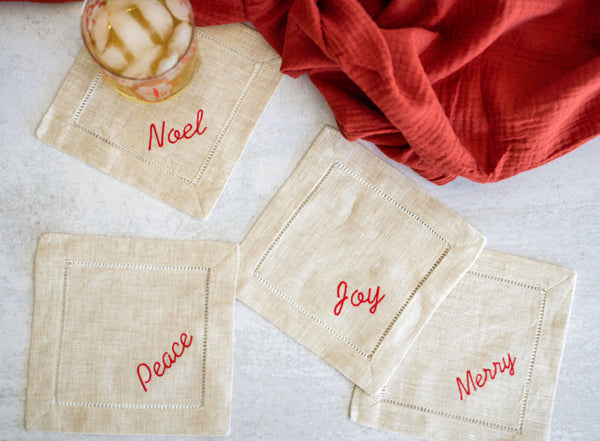 https://www.dotandarmy.com/cdn/shop/files/festive_word_coasters_linen_red_600x.jpg?v=1700395986