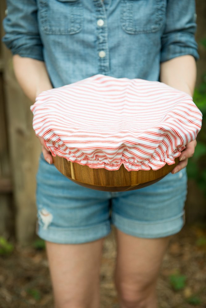 woman holding bowl with cloth bowl cover