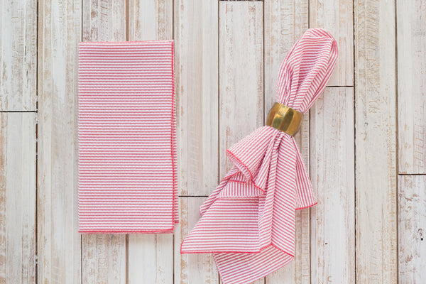 red colored seersucker cloth napkins on table