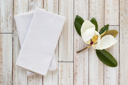 khaki colored seersucker cloth napkins on table with magnolia