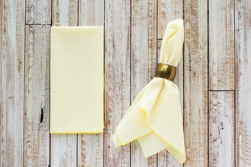 yellow colored seersucker cloth napkins on table